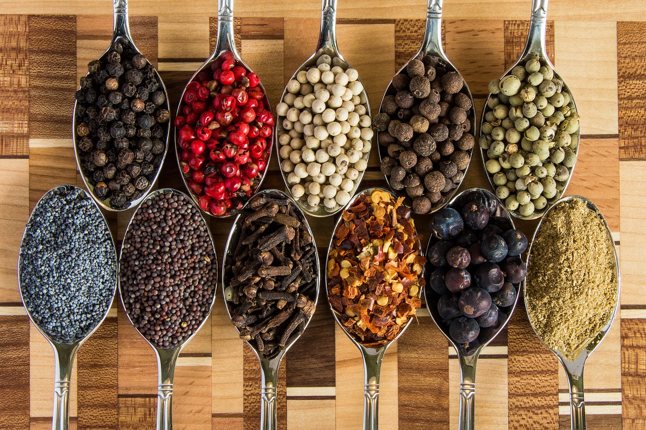 Variety of spices and seasonings in vintage spoons representing fiber-rich foods